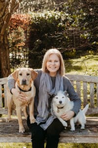 Picture of author Hayley Graham with her 2 dogs on a bench
